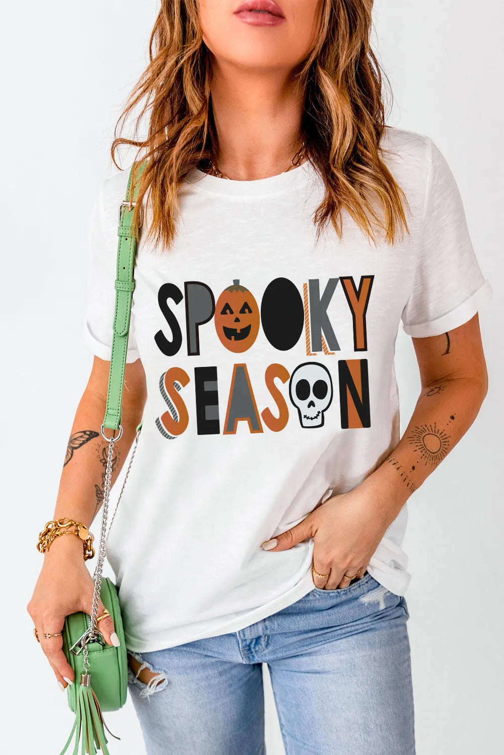 Spooky Season graphic T-shirt with pumpkin and skull design.