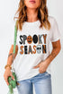 Spooky Season graphic T-shirt with pumpkin and skull design.
