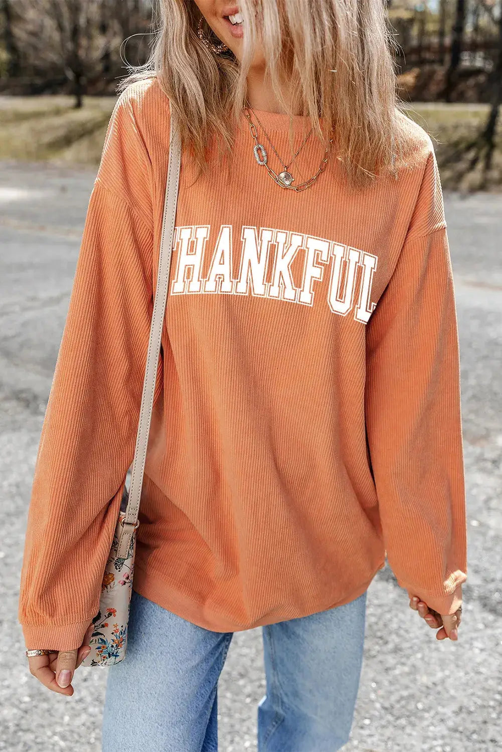 THANKFUL orange sweatshirt styled with jeans