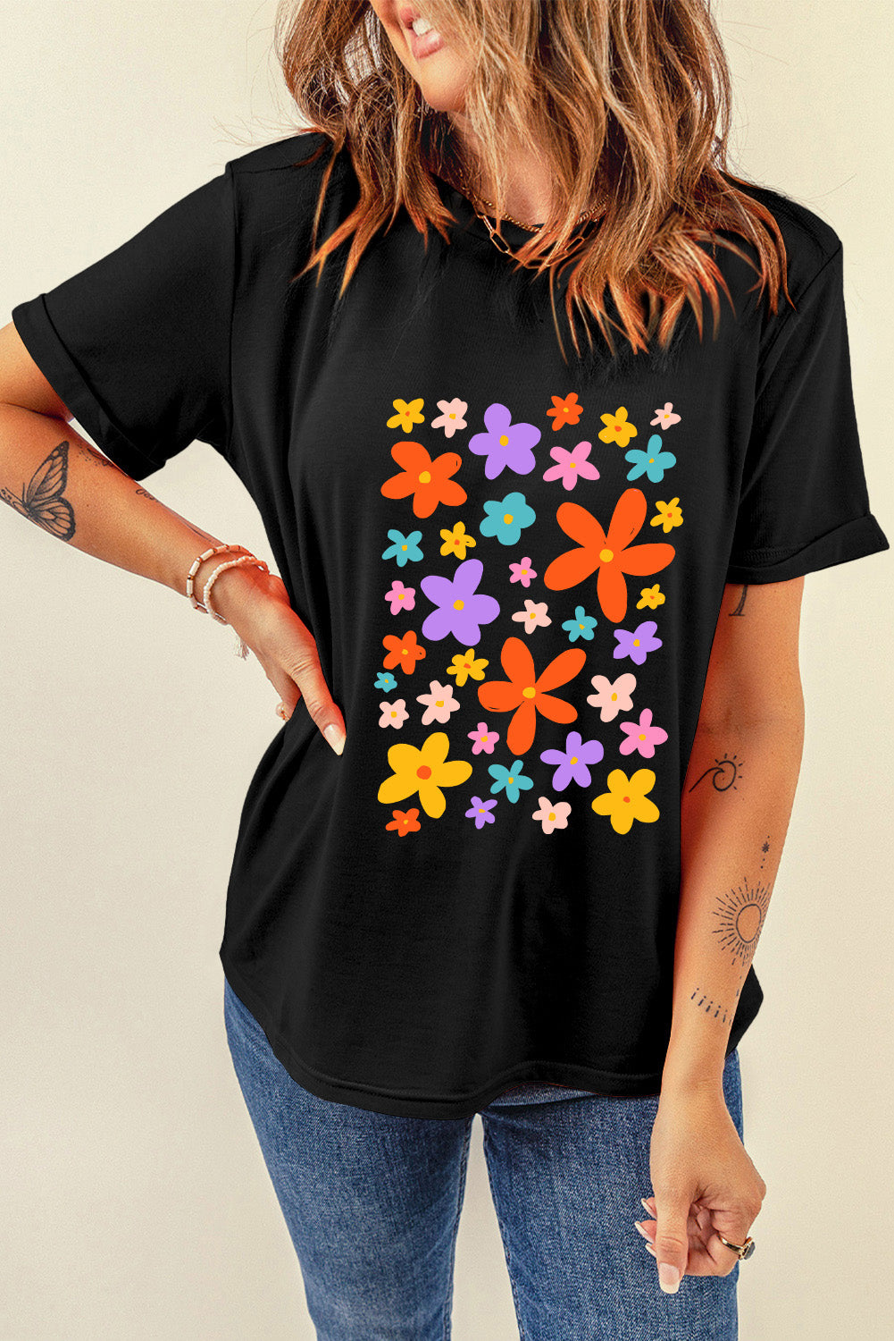 Short sleeve T-shirt with multicolored flower graphic on black fabric