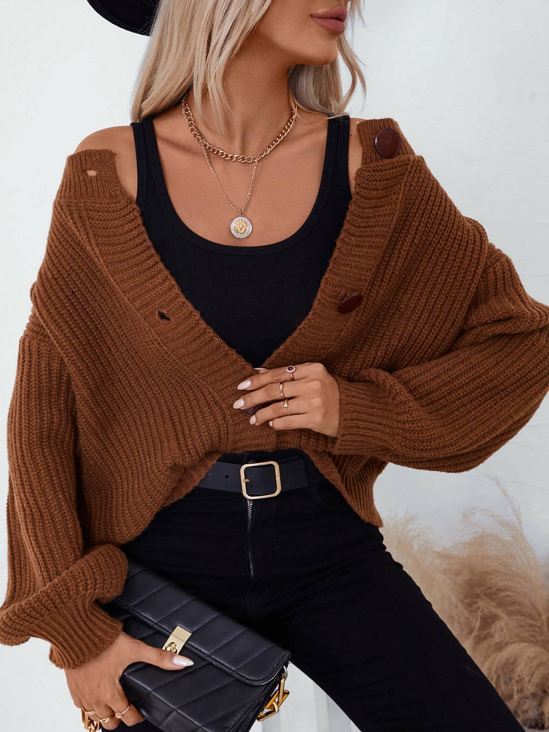 Brown cardigan worn off-shoulder with black top
