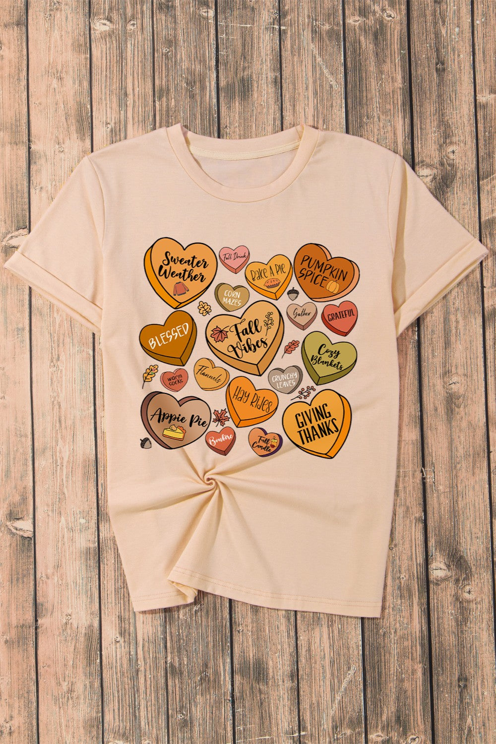 Heart graphic round neck short sleeve t-shirt on wooden surface