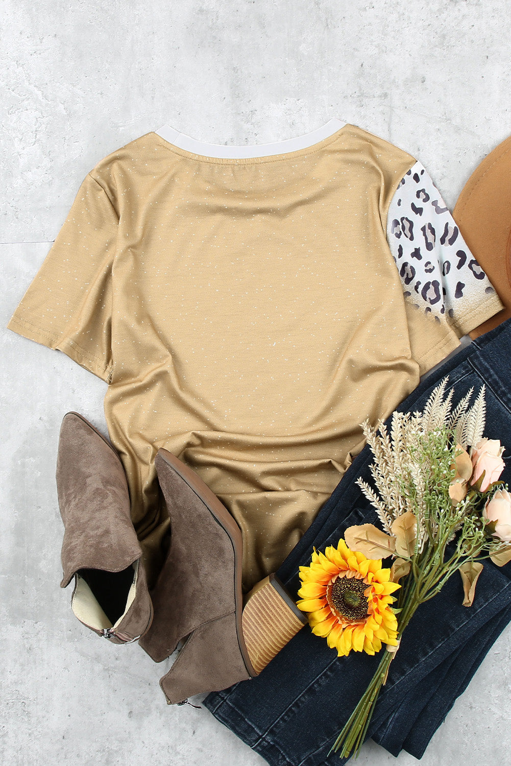 Back of T-shirt with leopard print sleeves, styled flat lay