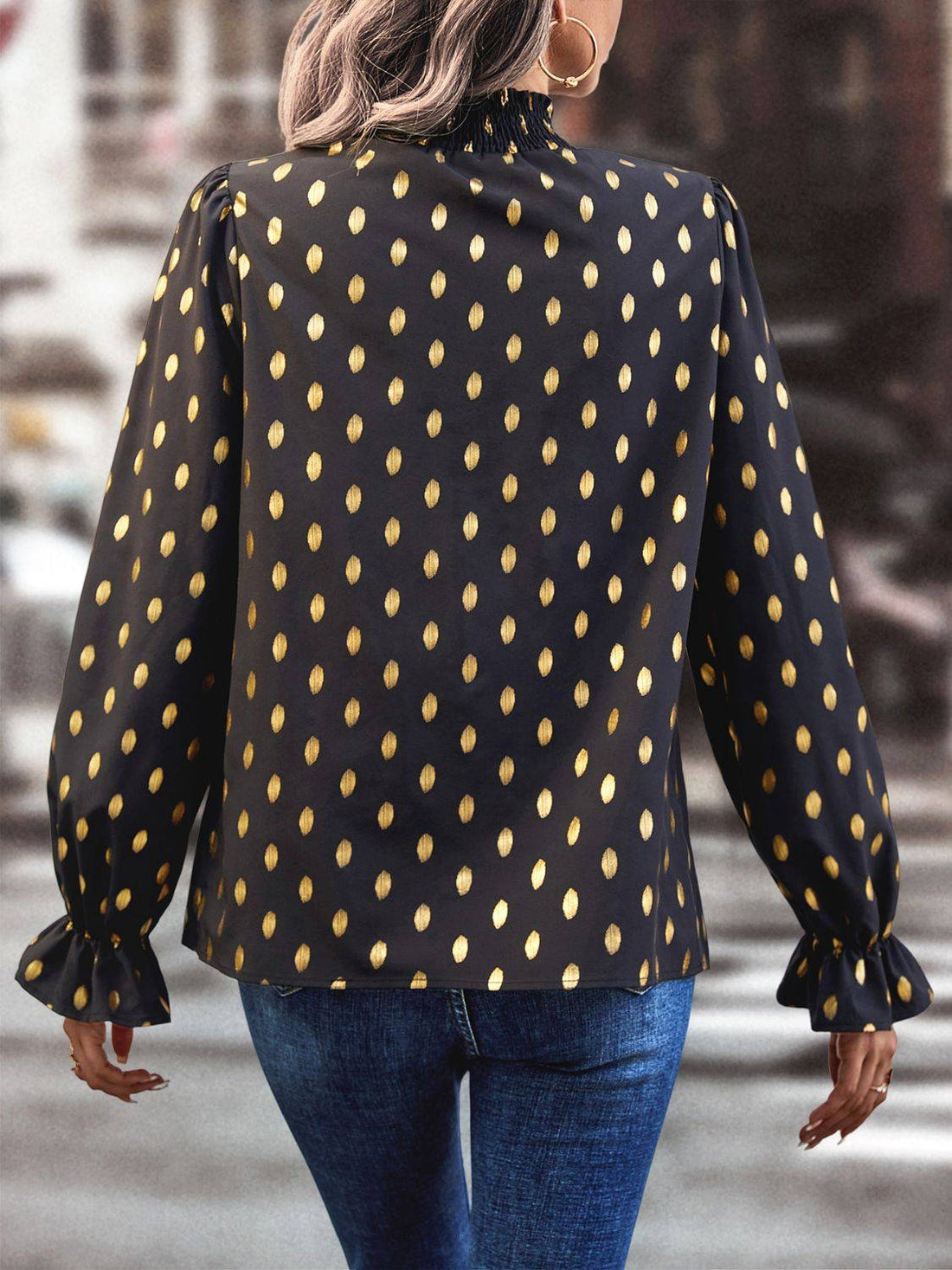 Back view of cutout printed mock neck blouse with flounce sleeves