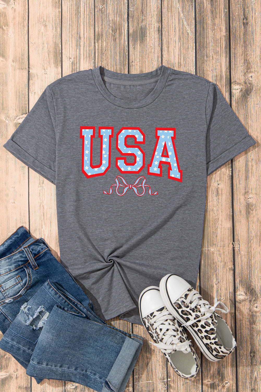 Flat lay of gray USA t-shirt with jeans and sneakers
