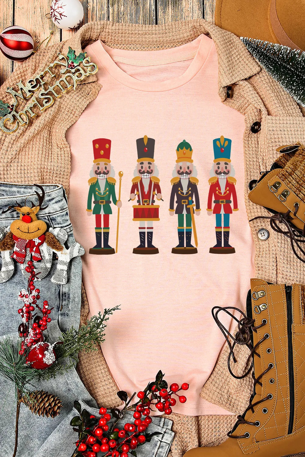 Flat lay of pink Nutcracker T-Shirt with festive decor