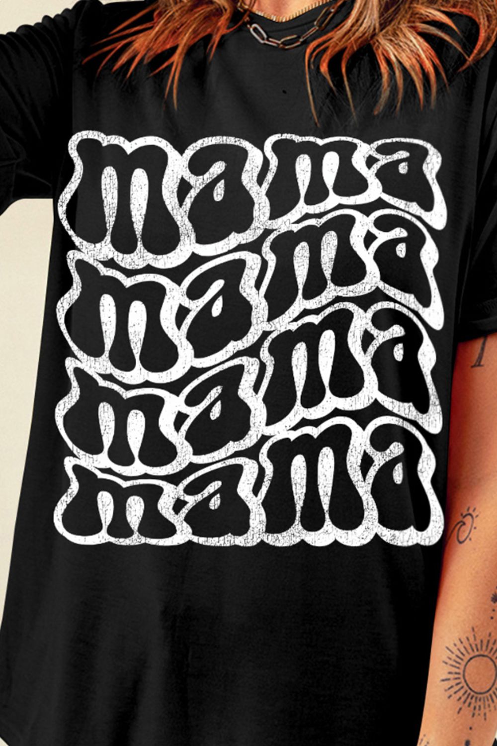 Close-up of MAMA text design on black t-shirt