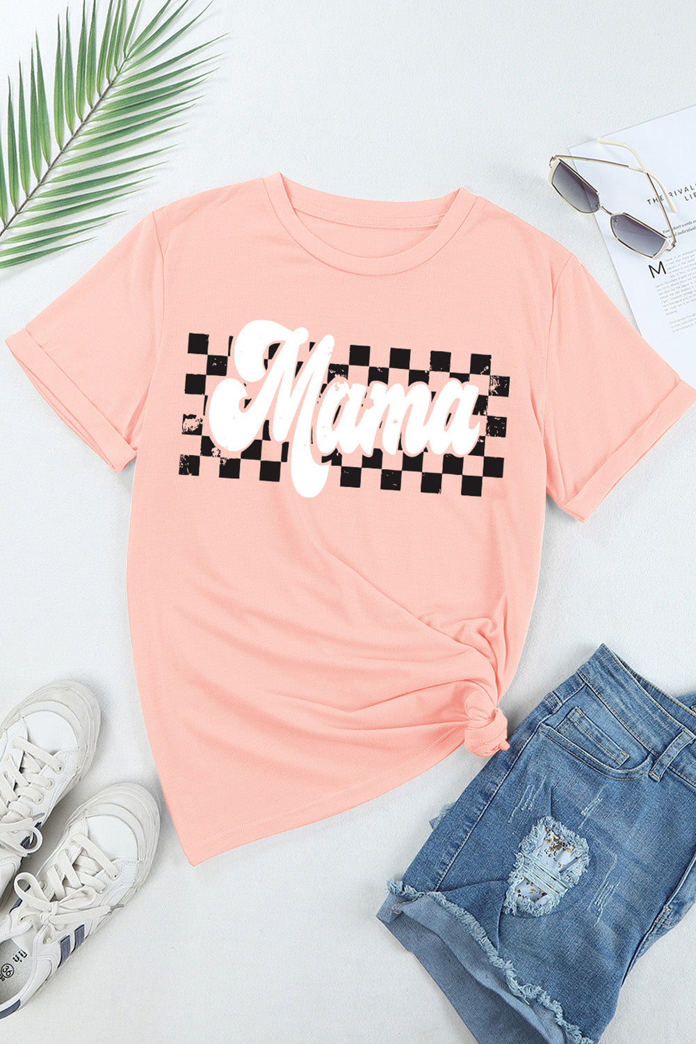 Flat lay of pink MAMA T-shirt with checkered design