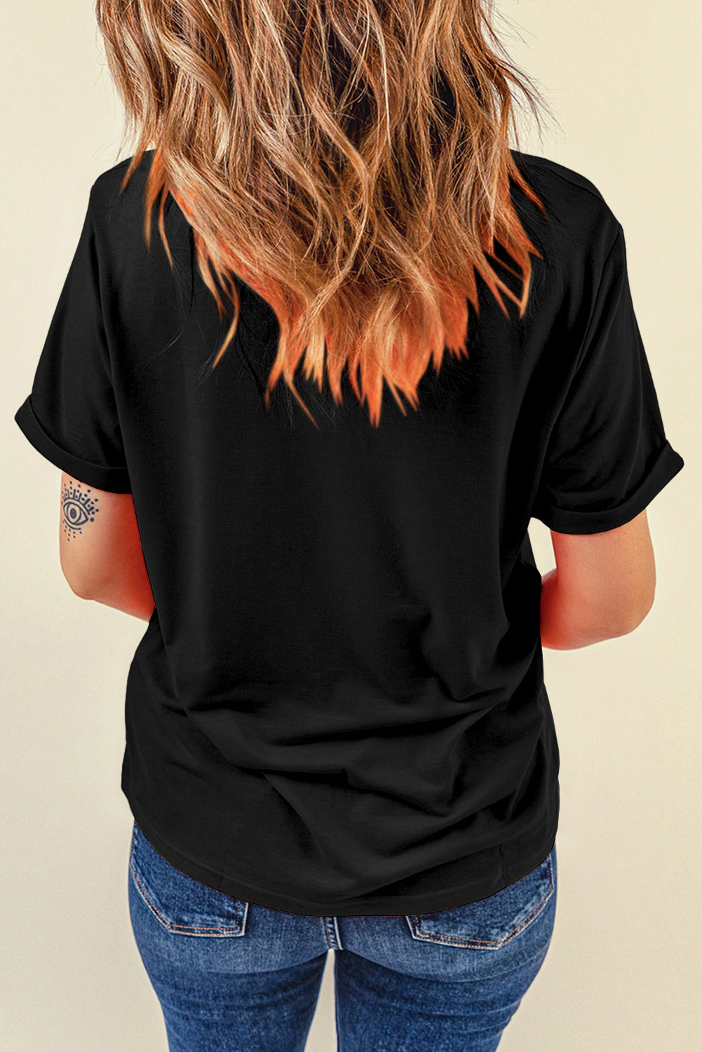 Back view of black T-shirt with rolled sleeves