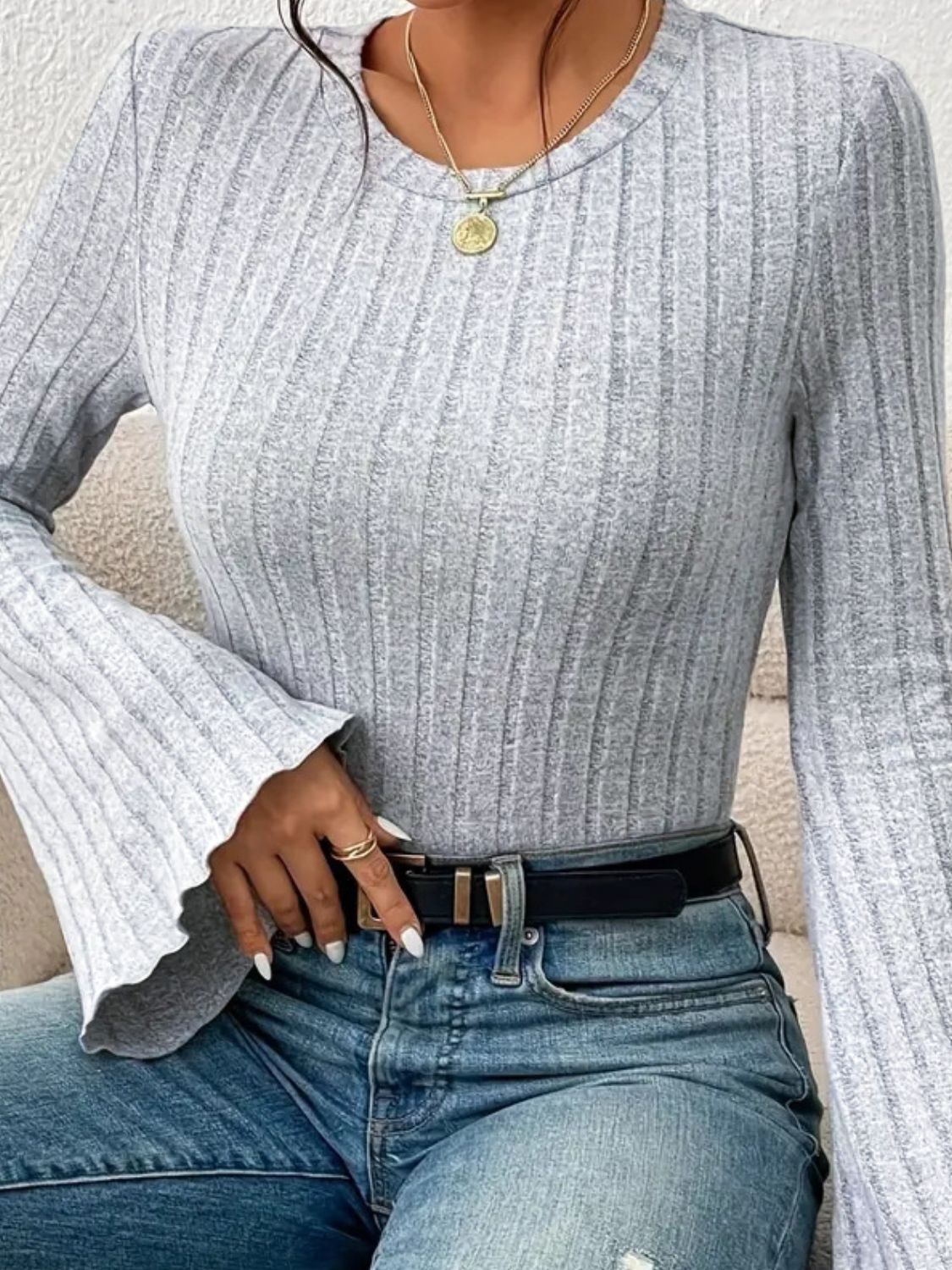 Close-up of gray ribbed t-shirt with flare sleeves