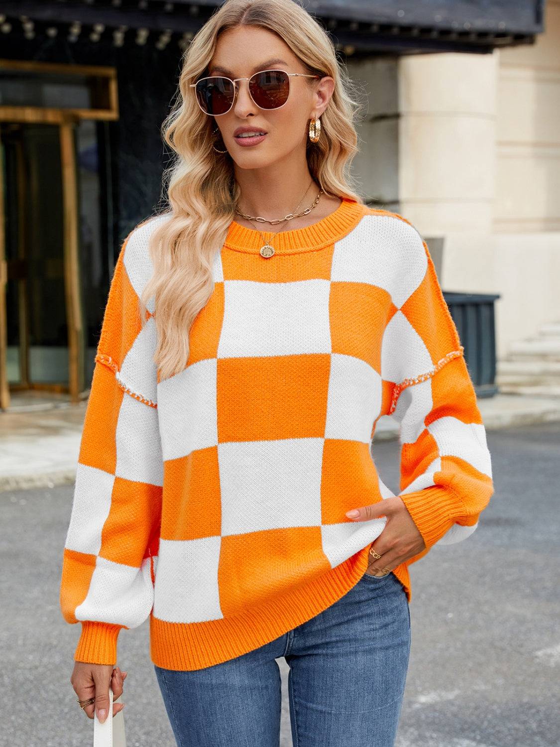 Front view of orange and white checkered sweater