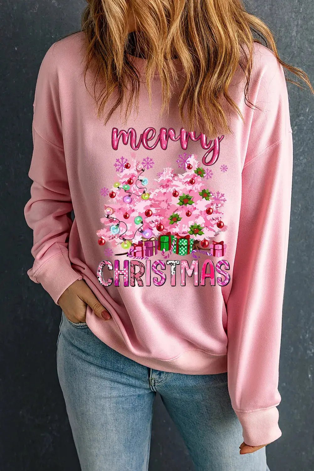 Pink Christmas sweatshirt featuring holiday graphics