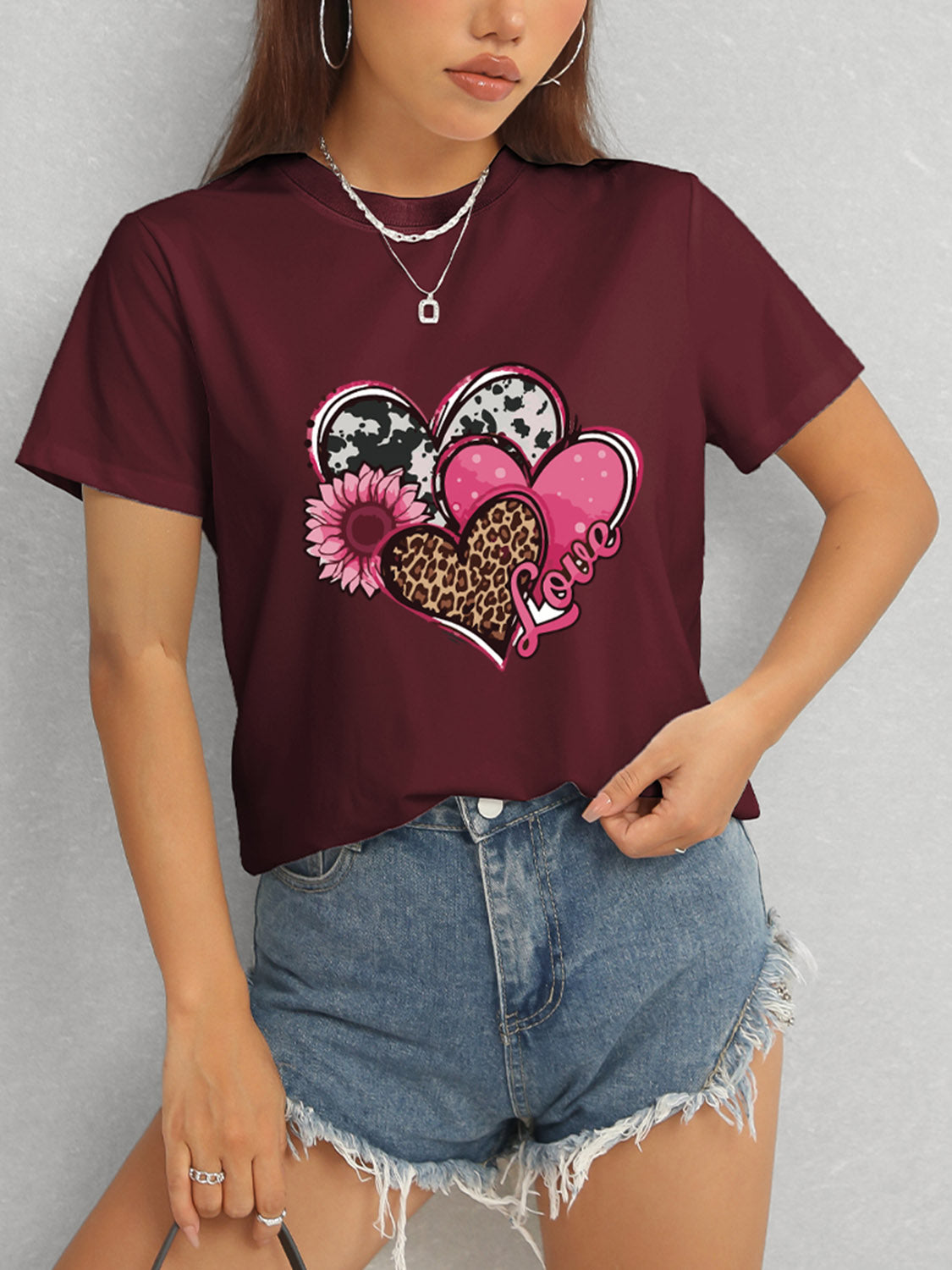 Maroon short sleeve t-shirt featuring heart and love graphic