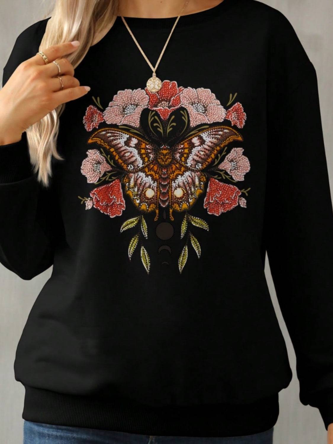 Close-up of butterfly and floral graphic on sweatshirt