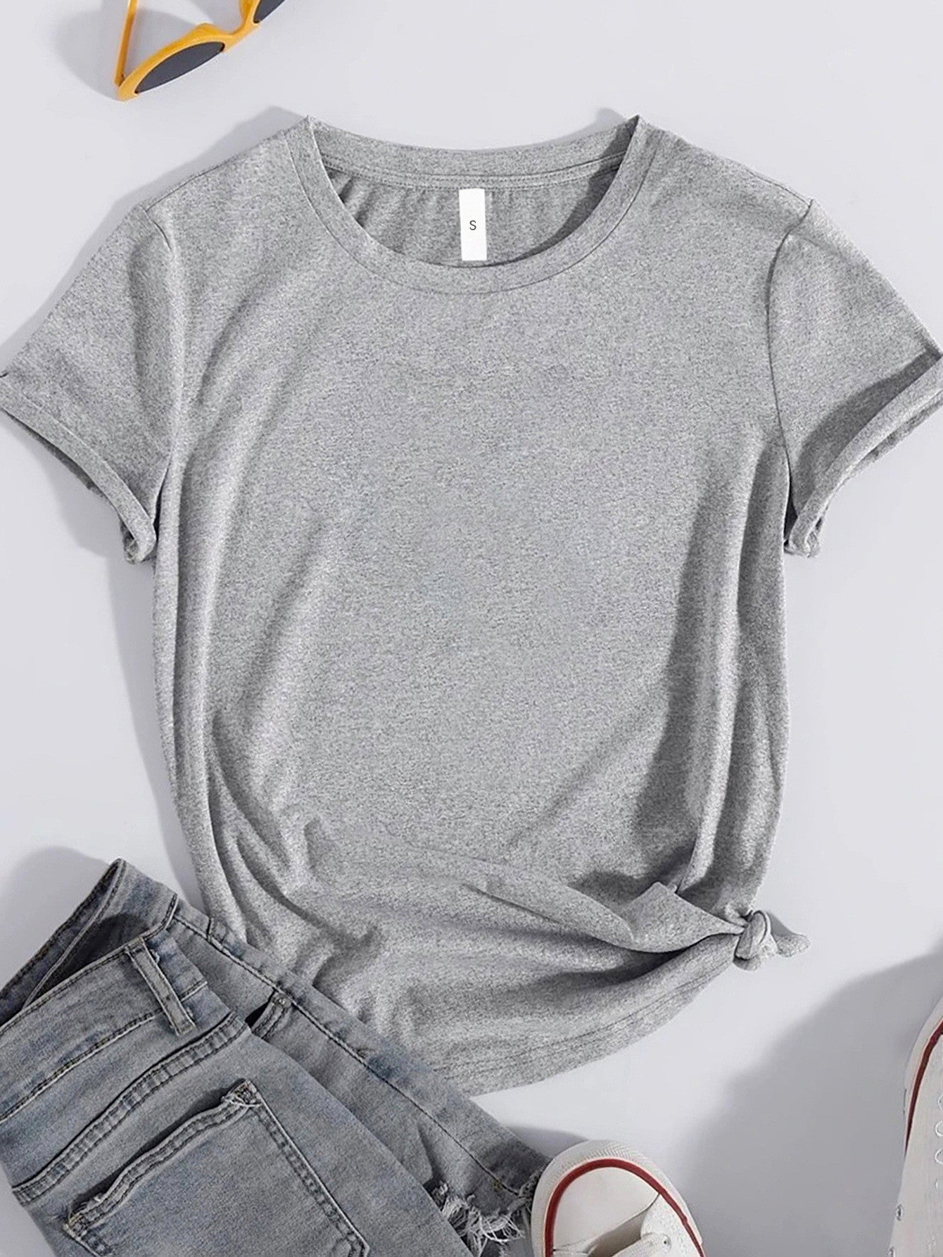 Plain gray round neck T-shirt styled with jeans