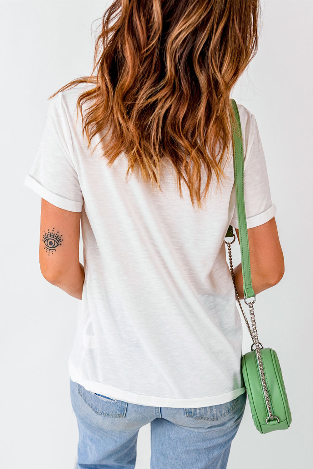 Back view of white T-shirt with rolled sleeves