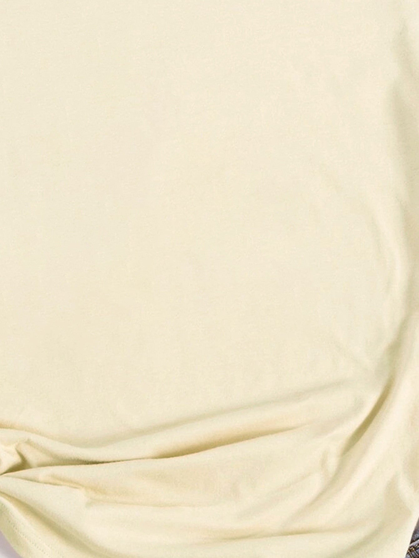 Close-up of cream T-shirt fabric and stitching