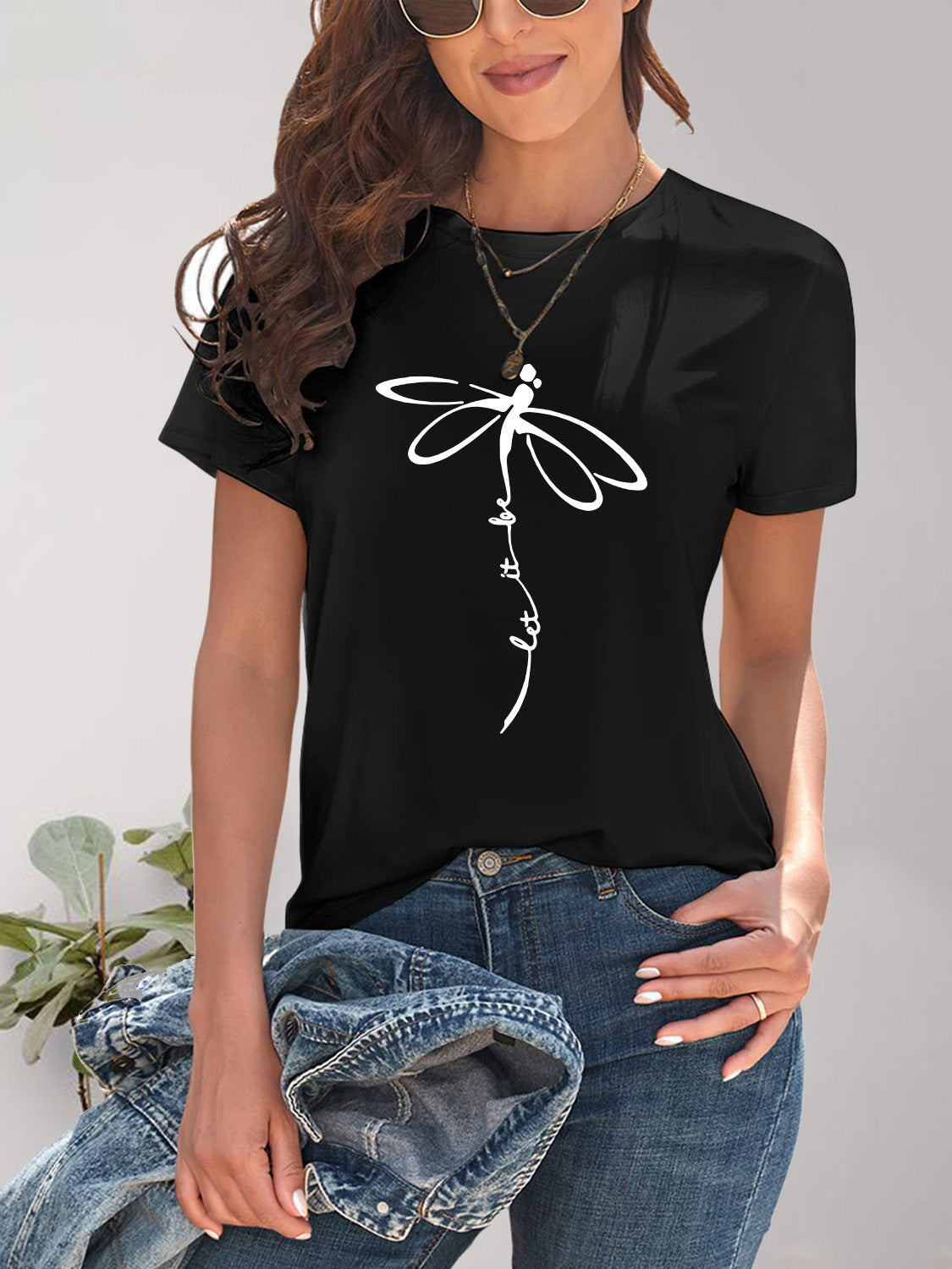 Black dragonfly graphic t-shirt with denim jeans