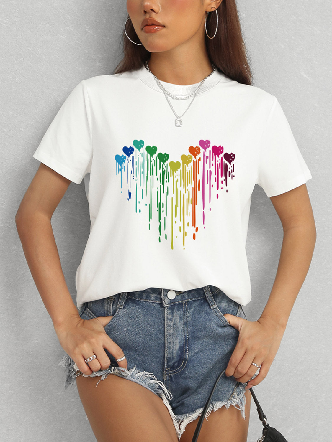 White short sleeve t-shirt featuring colorful heart pattern