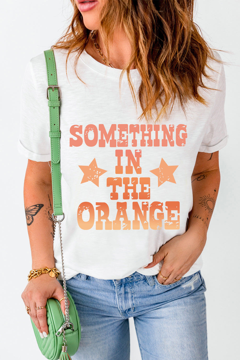 White T-shirt featuring orange text and stars design