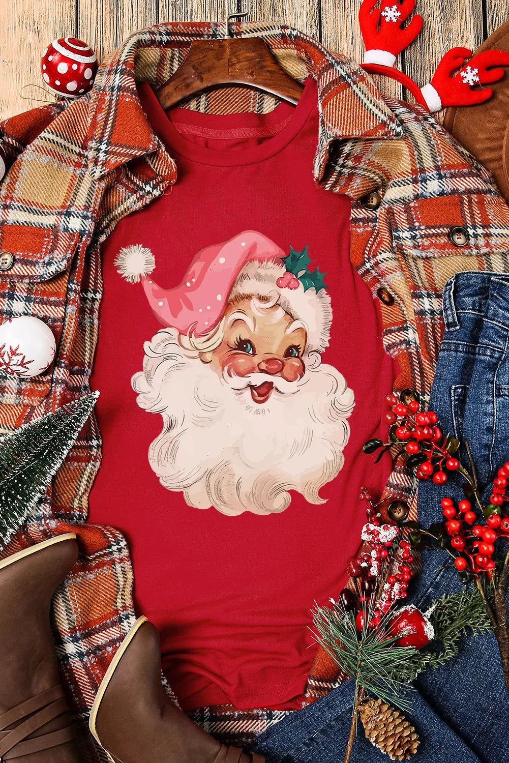 Santa t-shirt styled with plaid jacket and holiday decor.