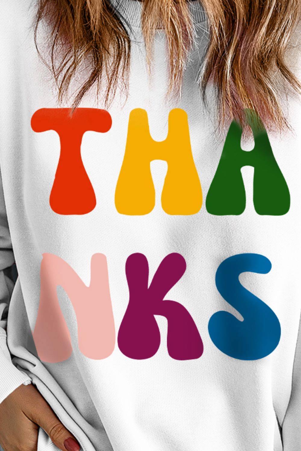 Close-up of colorful THANKS print on sweatshirt