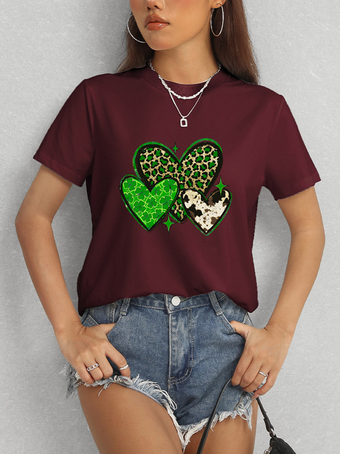 Burgundy t-shirt featuring green heart design