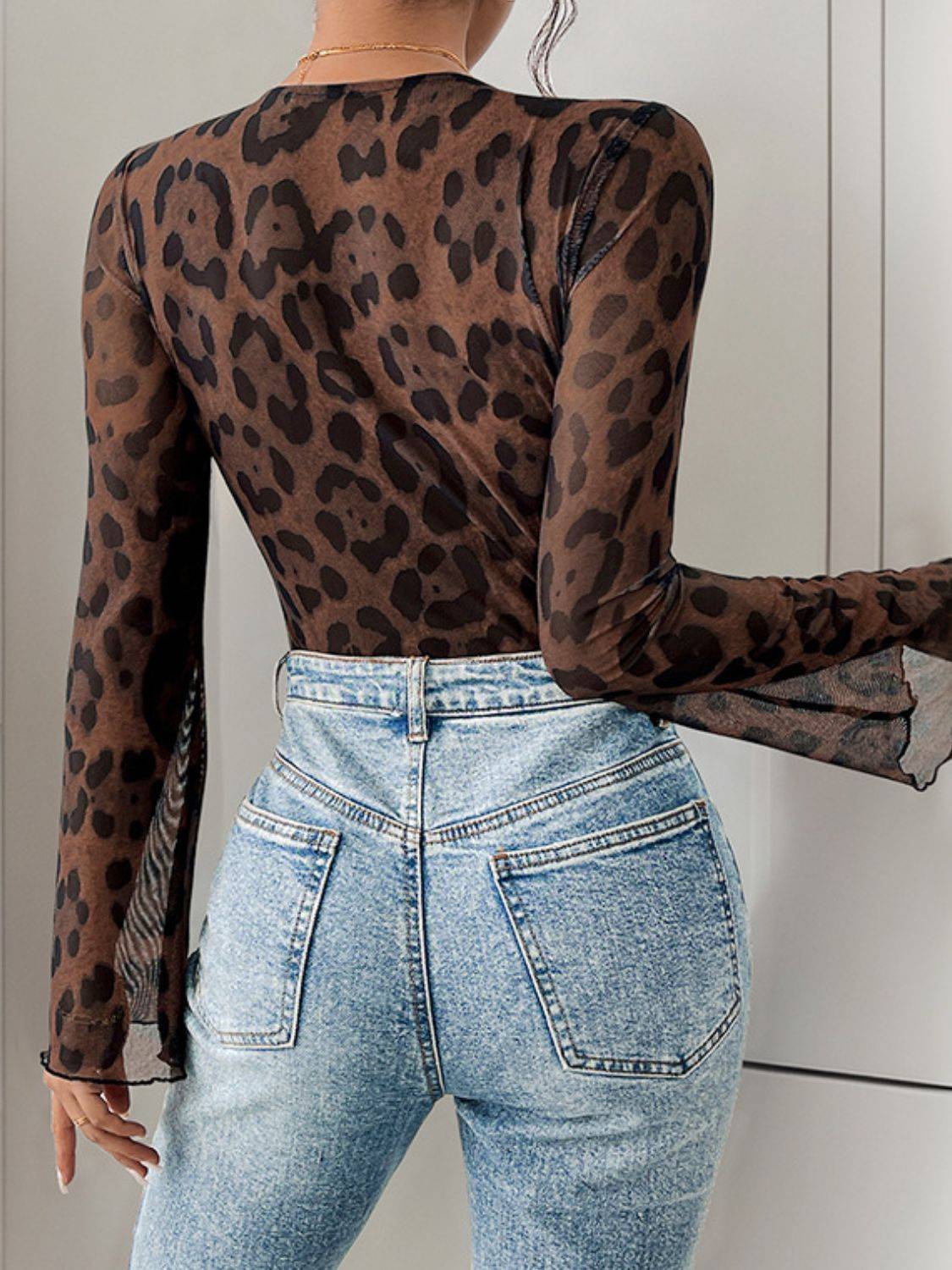 Back view of leopard lace bodysuit with denim jeans