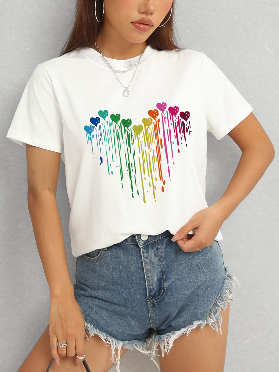White t-shirt with rainbow heart design and short sleeves