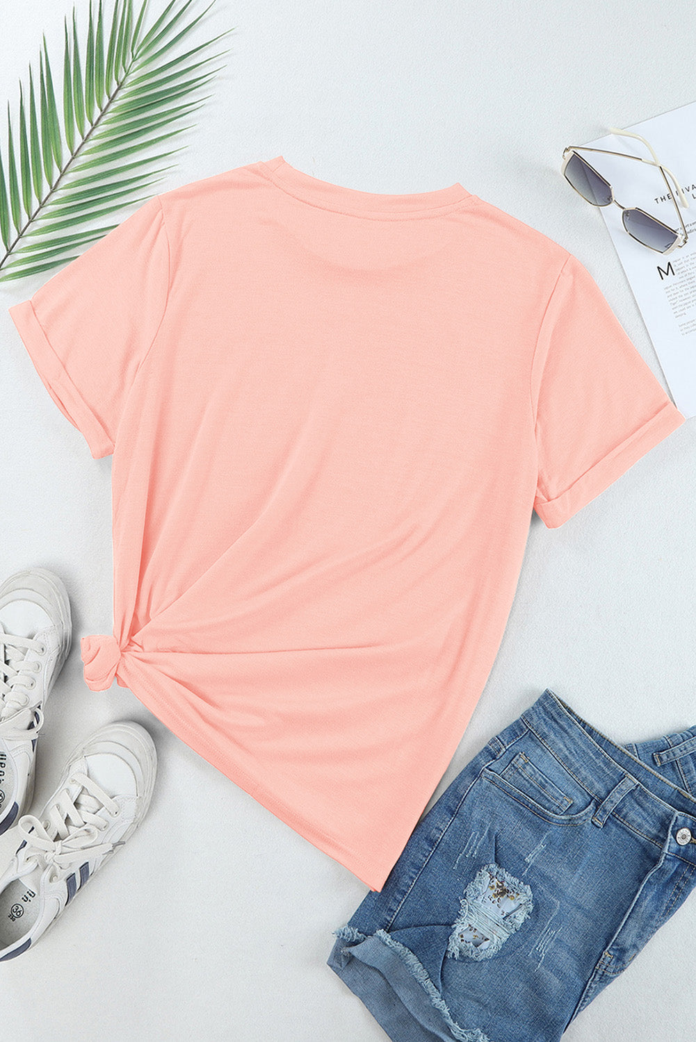 Back of pink MAMA T-shirt in flat lay with accessories