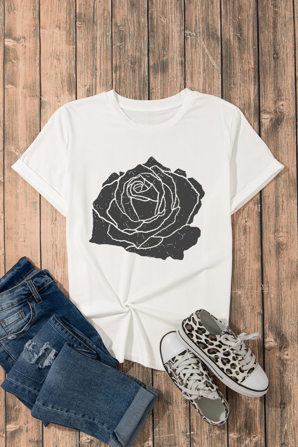White T-shirt with black rose graphic, styled with jeans and sneakers