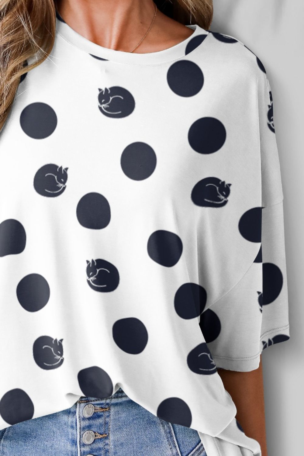 Close-up of polka dot t-shirt with cat design