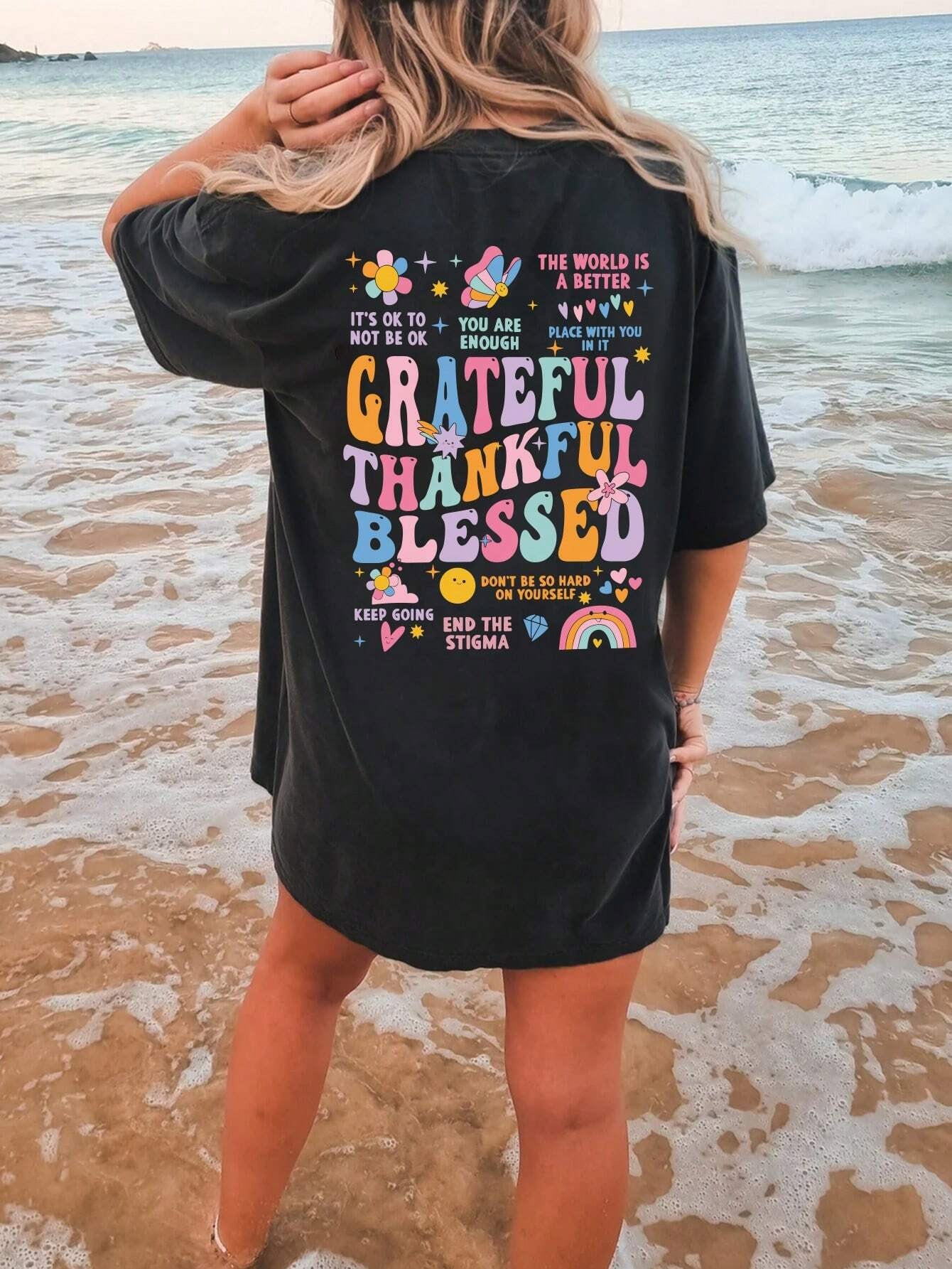 Black T-shirt with colorful gratitude graphic on back