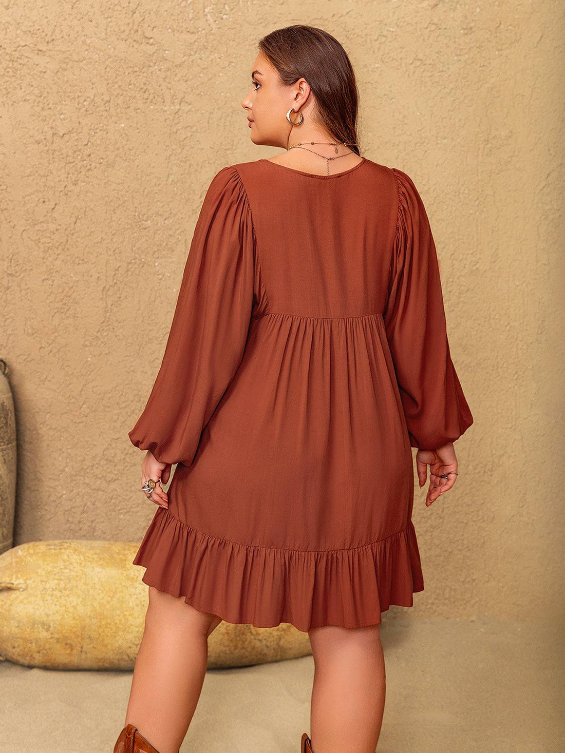 Back view of brown mini dress with balloon sleeves and ruffle hem