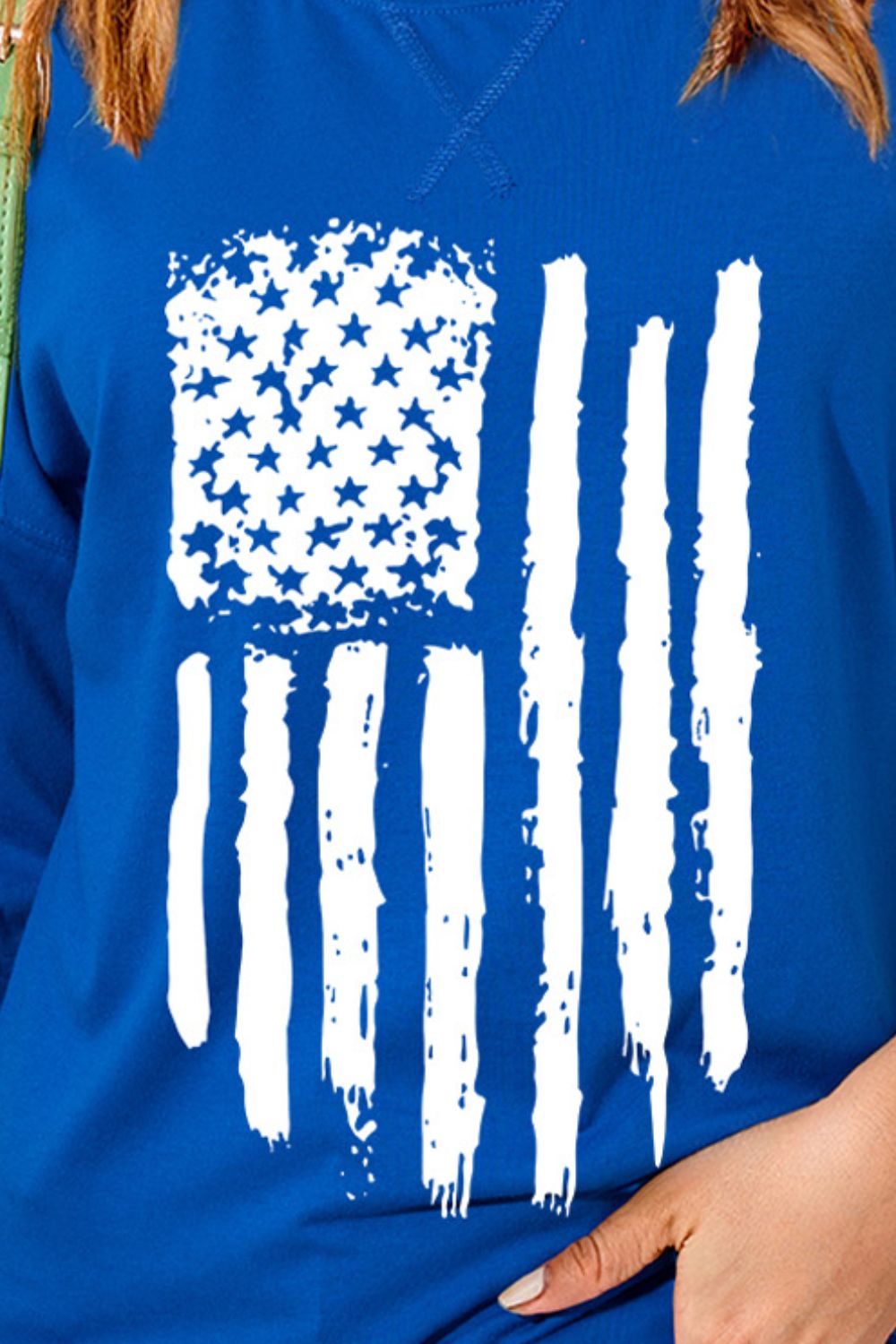 Close-up of US flag design on blue T-shirt