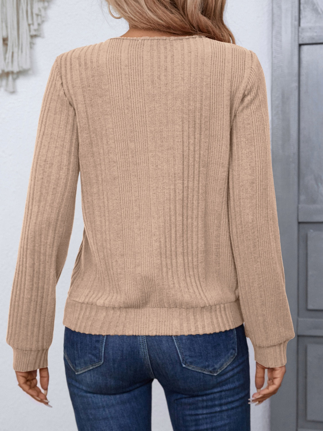 Back view of beige ribbed long sleeve top