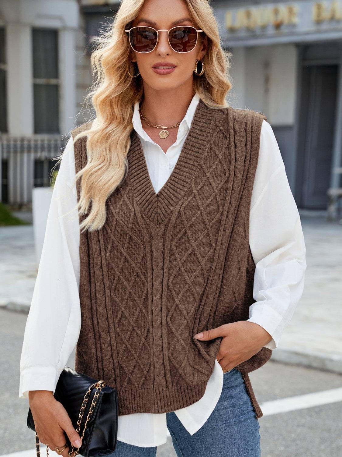 Brown cable knit V-neck sweater vest with sunglasses