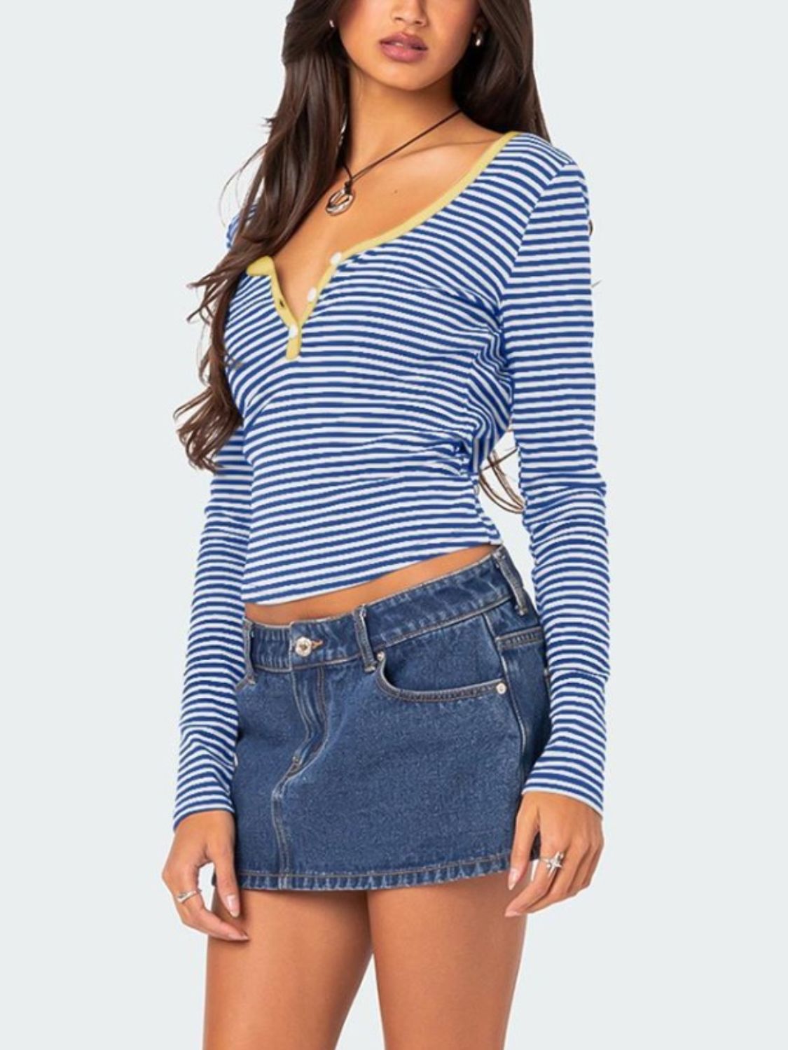 Blue striped T-shirt with yellow trim paired with denim skirt