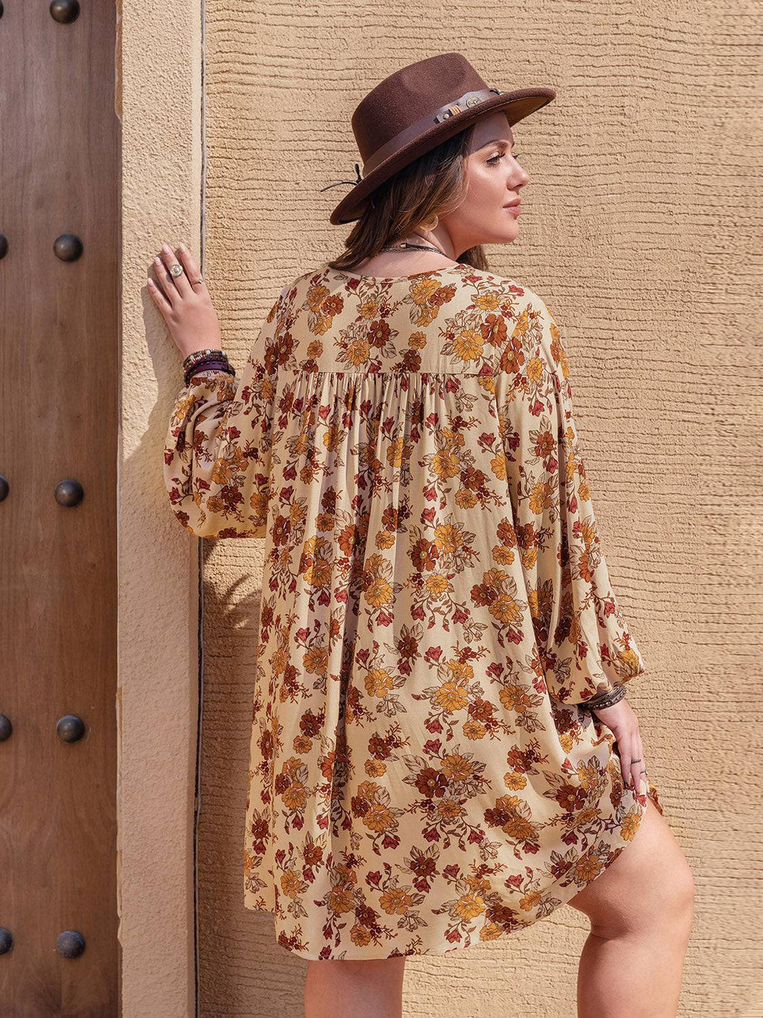 Back view of floral V-neck mini dress with balloon sleeves