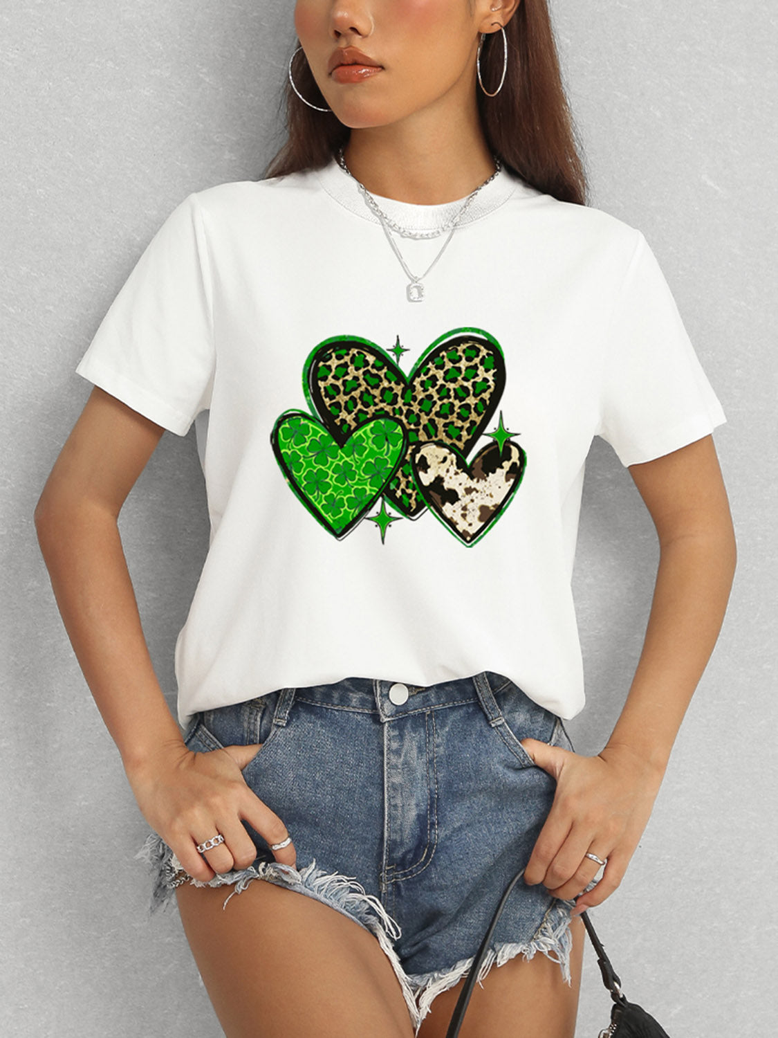 White t-shirt featuring green heart design