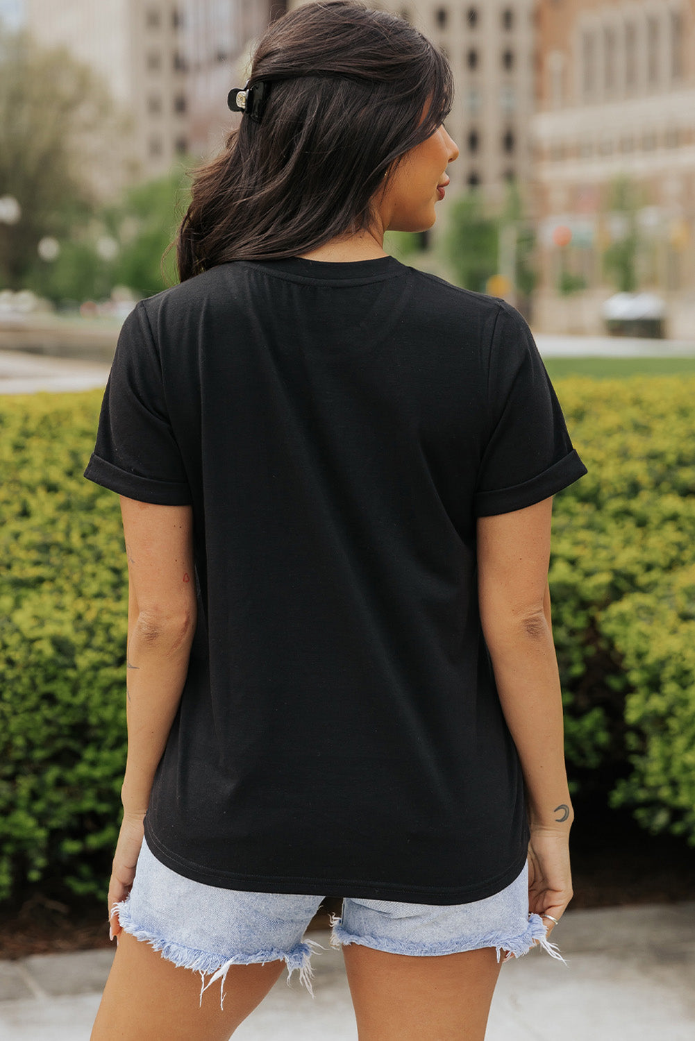 Back view of black round neck short sleeve T-shirt.