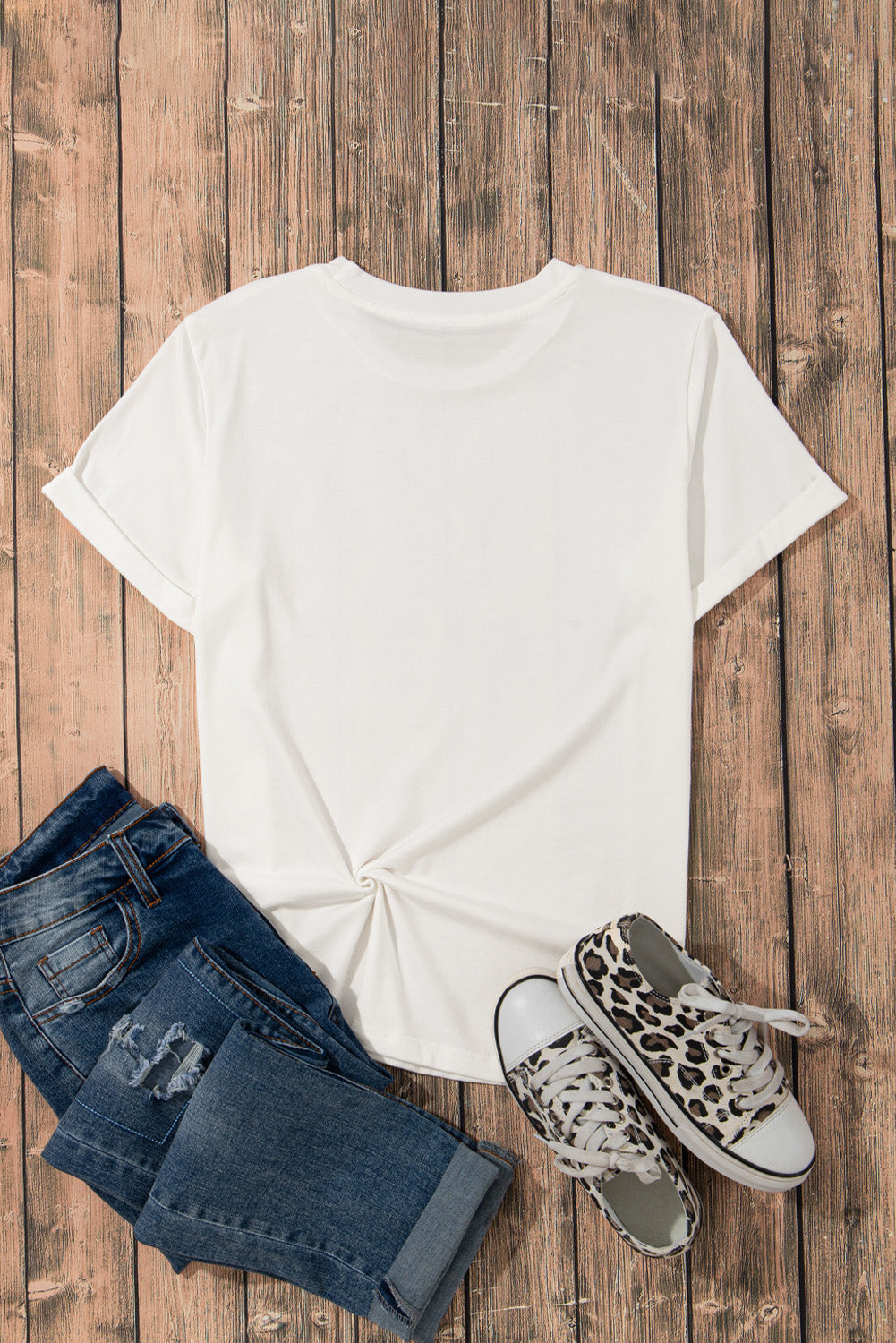Flat lay of plain white T-shirt with jeans and sneakers