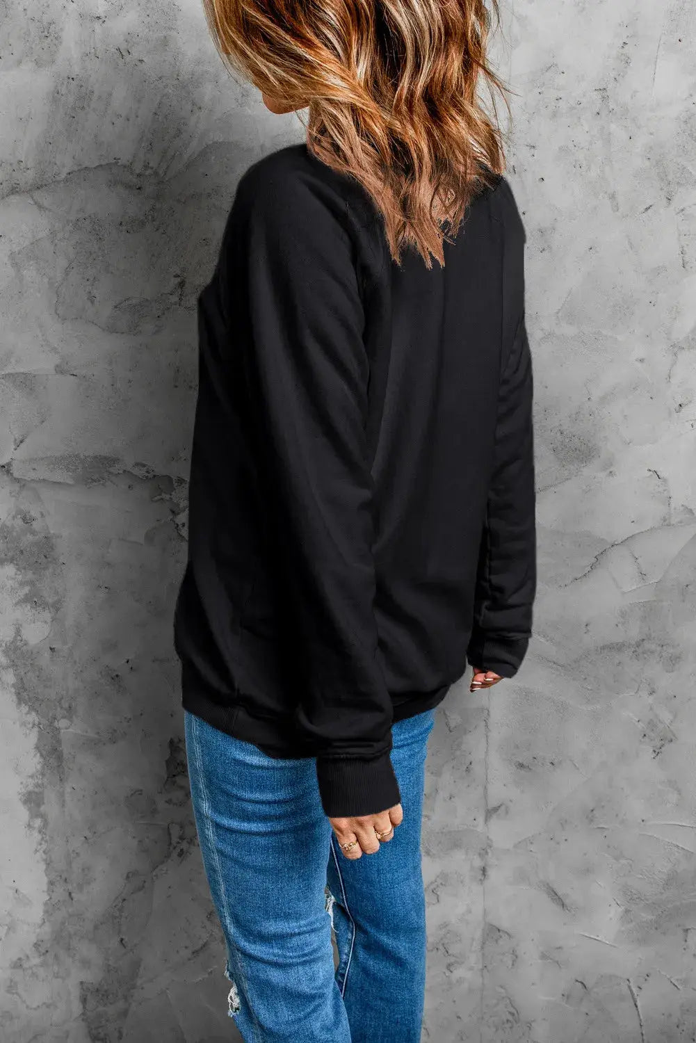 Back view of black long sleeve ghost sweatshirt