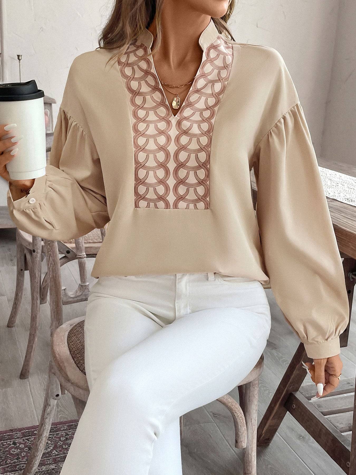 Perfee printed notched long sleeve blouse, seated with coffee