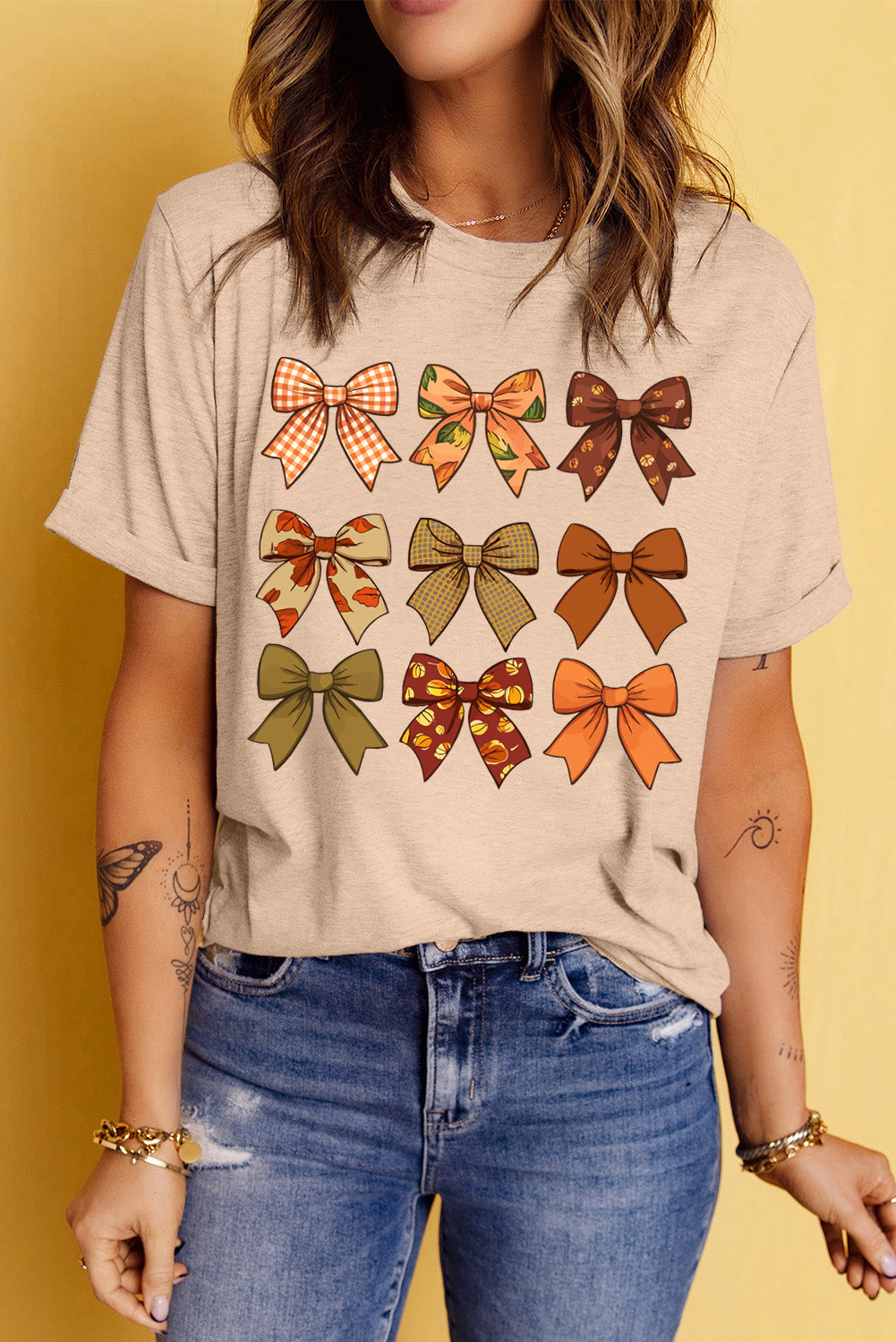 Round neck T-shirt featuring bow graphic, short sleeves.