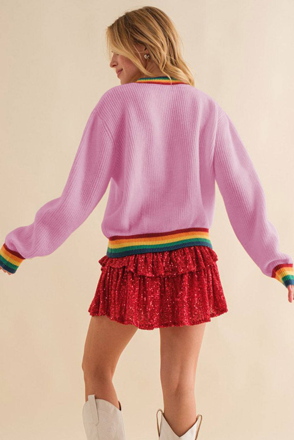 Back view of pink ribbed sweater with rainbow trim
