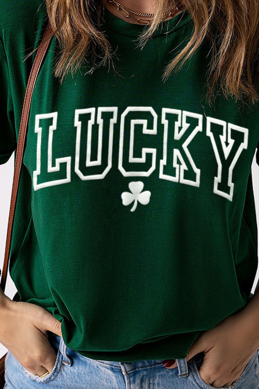 Close-up of LUCKY text on green t-shirt