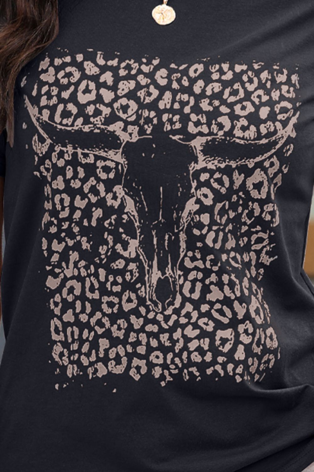 Close-up of black T-shirt with bull skull and leopard print design