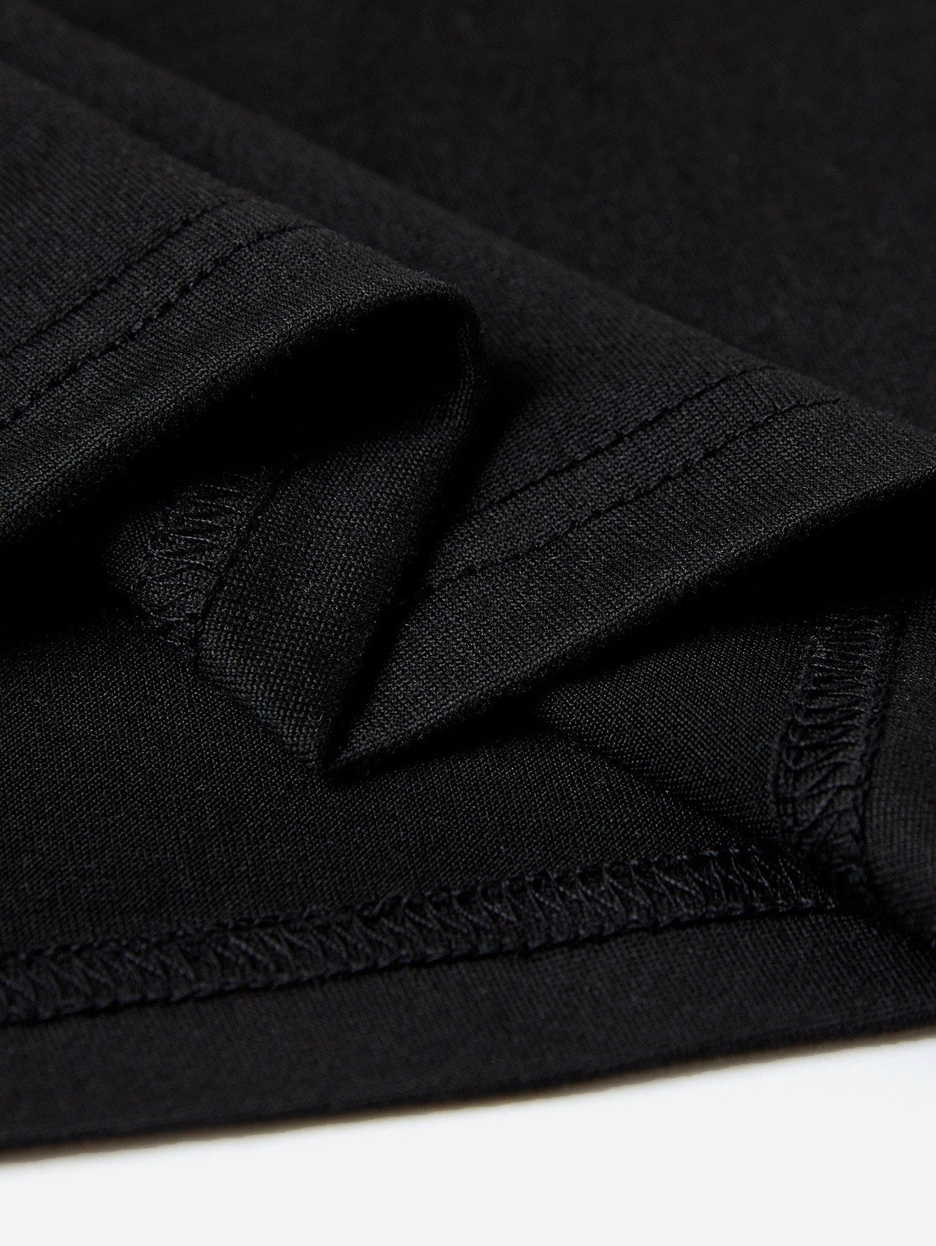 Close-up of black t-shirt hem stitching detail