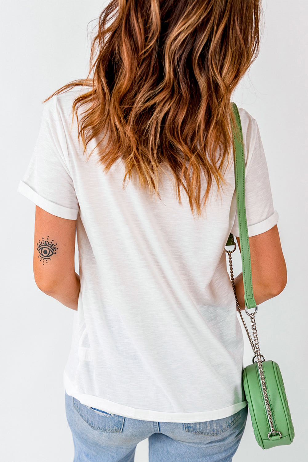 Back view of white T-shirt with rolled sleeves.
